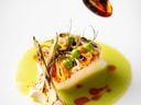 Fein angerichtetes Gourmetgericht mit Sauce.