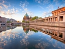 Berliner Dom und Brücke spiegeln sich in der Spree.