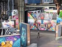 Grosse bunte Wandgemälde in einer Ausstellungshalle.