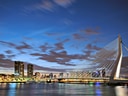 Erasmusbrücke in Rotterdam bei Dämmerung mit Skyline.