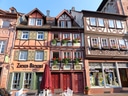 Fachwerkhäuser mit Geschäften und Blumen in der Altstadt.