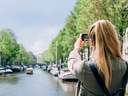 Frau fotografiert Kanal in Amsterdam.