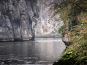 Fluss von hohen Felsen und Wald gesäumt.