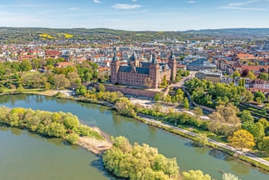 Luftaufnahme einer historischen Stadt mit Schloss und Fluss.