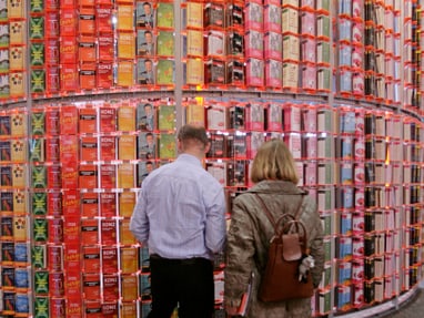 buchmesse-frankfurt.jpg Zwei Personen betrachten Wand voller Teeschachteln.