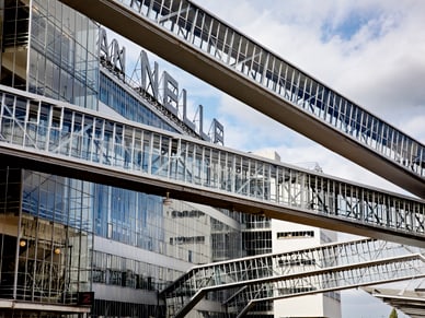 Mehrstöckige Stahlglas-Verbindungsbrücken der Van-Nelle-Fabrik in Rotterdam unter bewölktem Himmel.