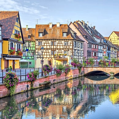 Malerische Fachwerkhäuser an einem Kanal mit Brücke in einer Altstadt.