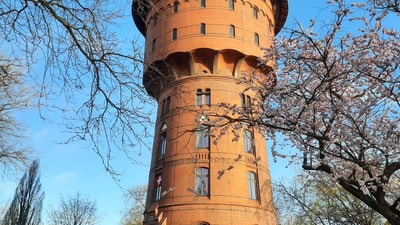 1621550.jpg Historischer Wasserturm im Frühling mit blühenden Bäumen.