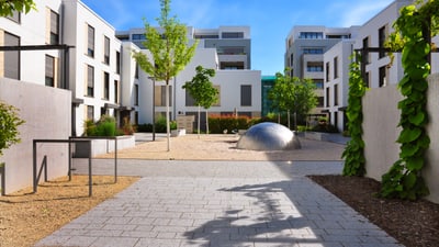 Moderne Innenhofanlage mit Bäumen und Gehwegen.