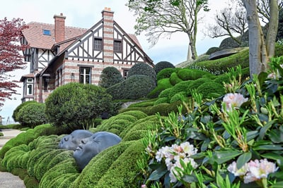 jardins-detretat.jpg Eindrucksvolles Herrenhaus mit gepflegtem Garten und Kopfbüsten.