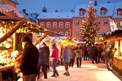 bamberg.jpg Weihnachtsmarkt mit Ständen und beleuchtetem Weihnachtsbaum.