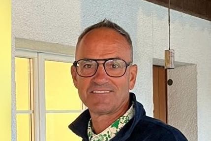 Mann mit Brille in einem Raum mit Fenster.